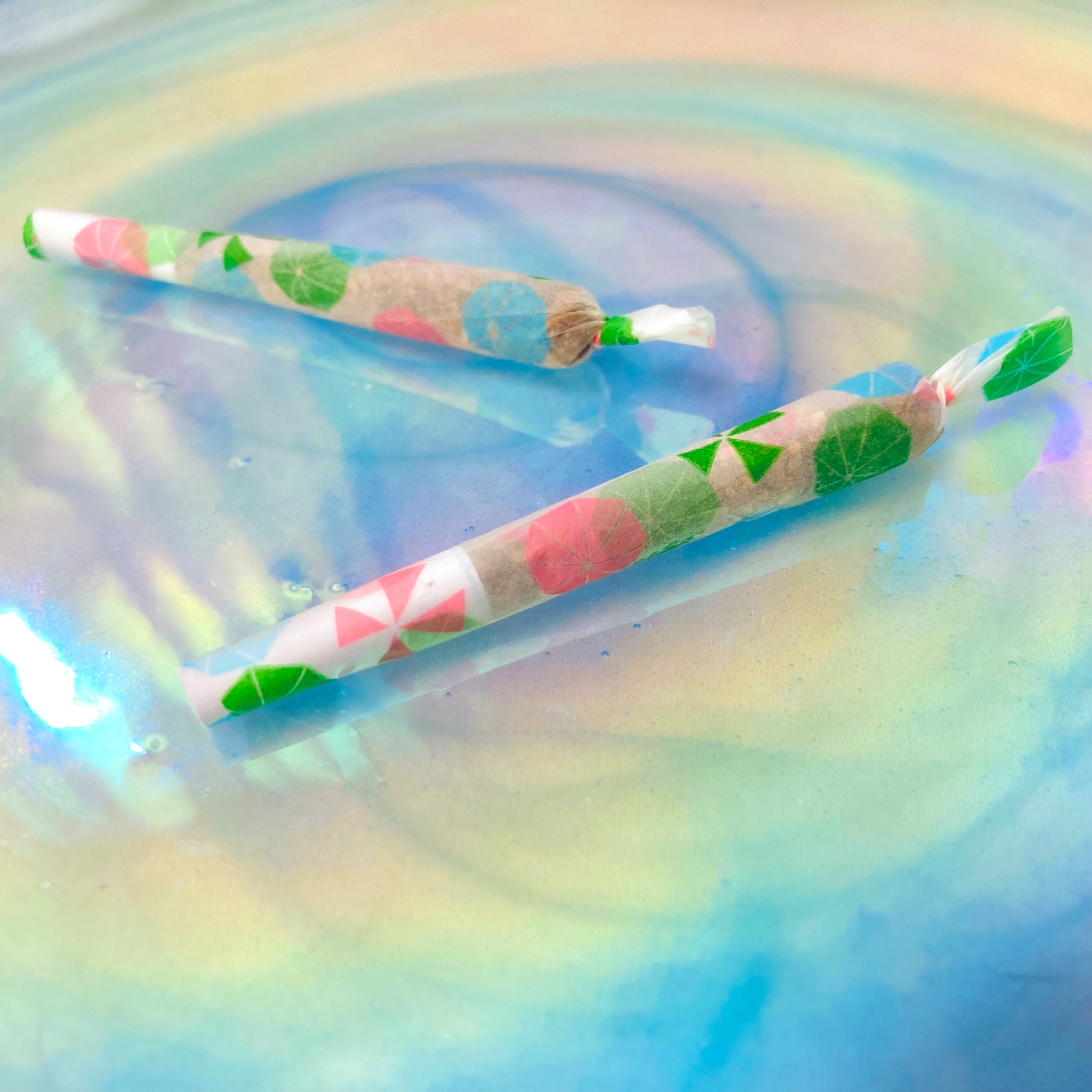 The Boardwalk Papers: beachy parasol, sun umbrella, umbrella printed rolling papers. These designer rolling papers are girly, pretty, vegan, cute, cool, standard size, high quality, even burn, natural dyes, best tasting, slow burn.