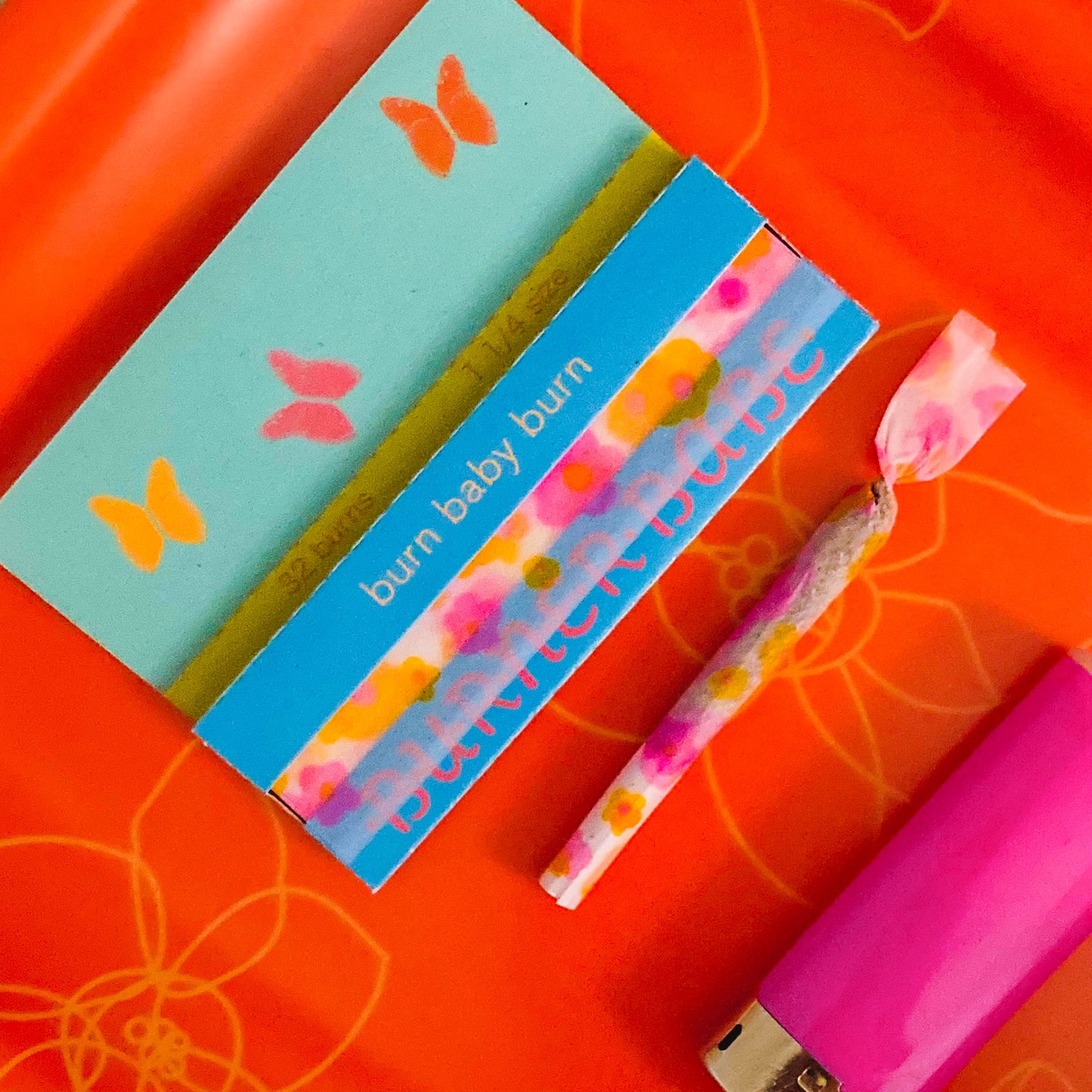 The Lucky Papers, set of 10: purple and orange floral papers. These designer rolling papers are girly, pretty, vegan, cute, cool, standard size, high quality, even burn, natural dyes, best tasting, slow burn.