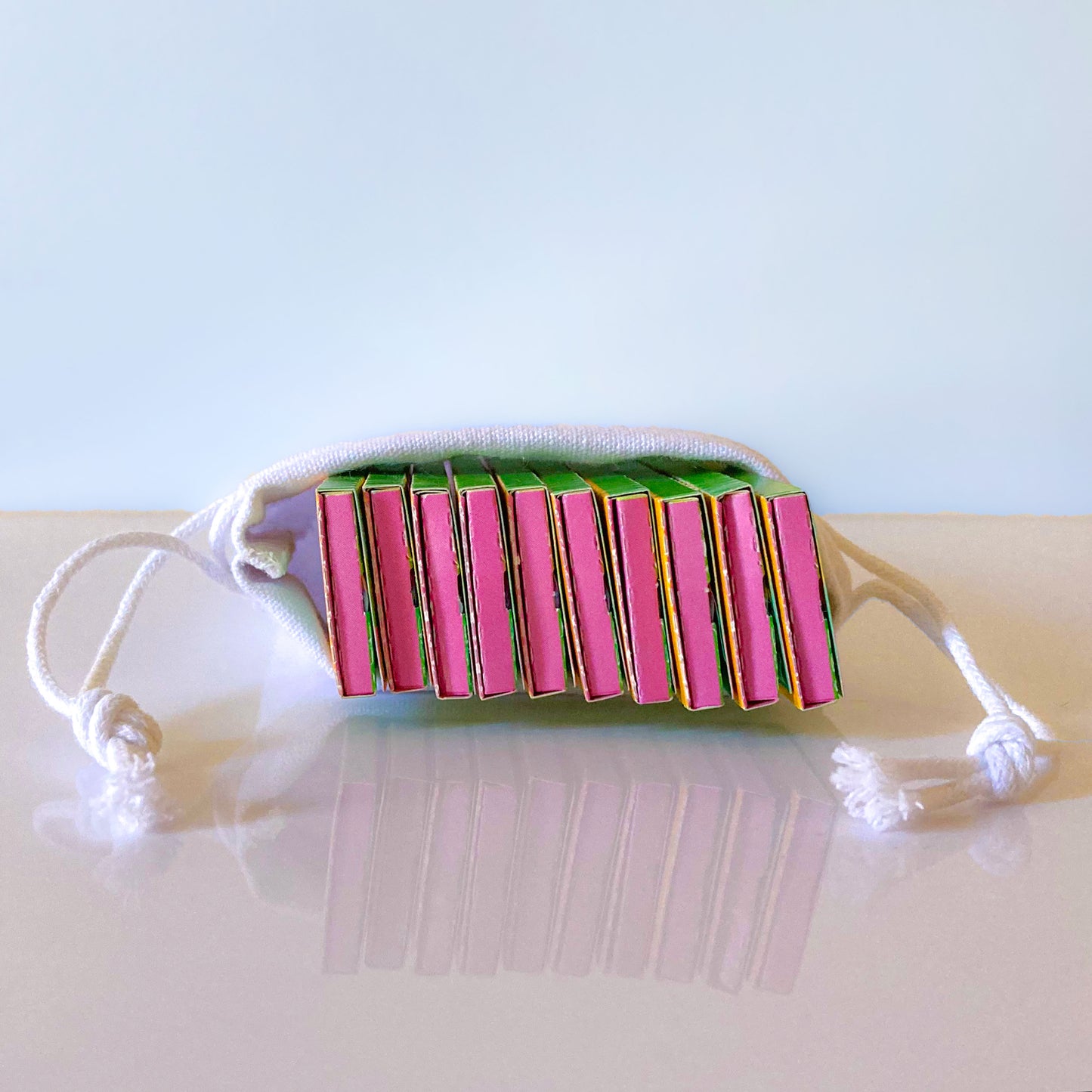 The Chick Lick Papers, set of 10 in a white cotton drawstringpouch: popsicle patterned rolling papers. These designer rolling papers are girly, pretty, vegan, cute, cool, standard size, high quality, even burn, natural dyes, best tasting, slow burn.