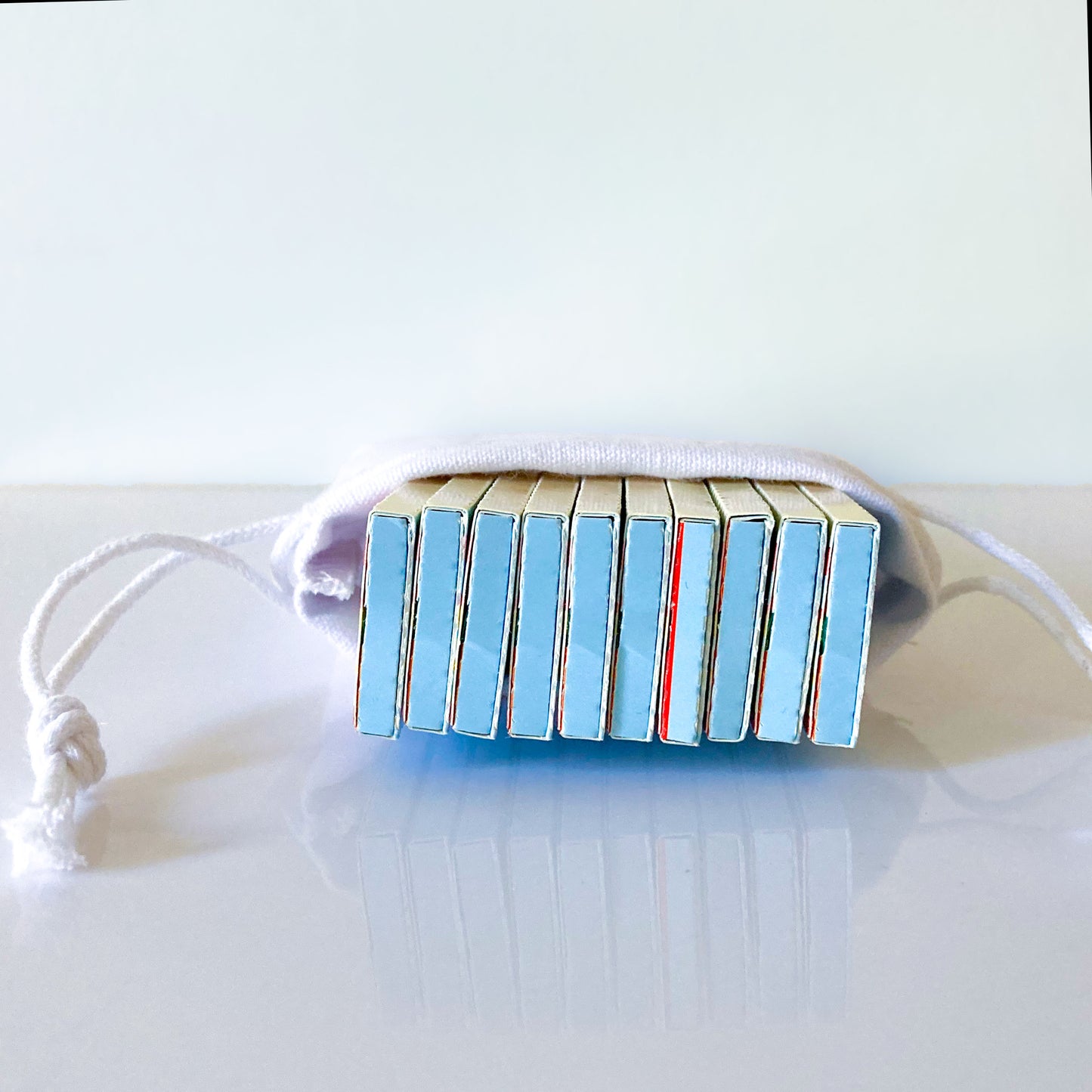 The Classic Rolling Papers, set of 10 in a white cotton pouch: blue striped rolling papers. These designer rolling papers are girly, pretty, vegan, cute, cool, standard size, high quality, even burn, natural dyes, best tasting, slow burn.