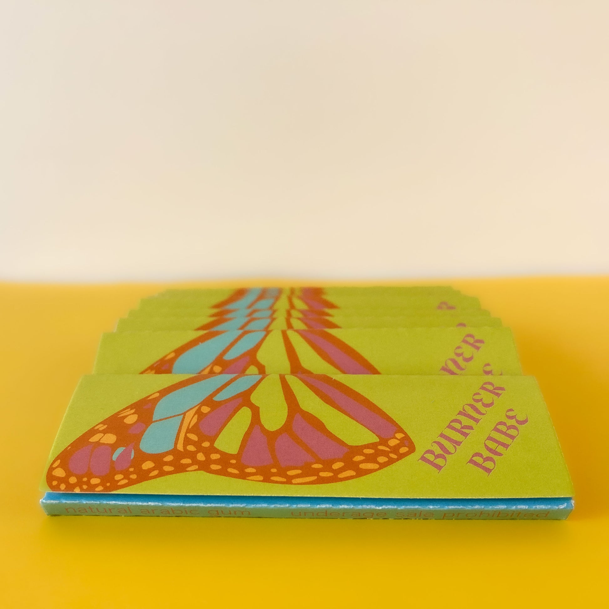 The Lucky Papers, set of 10: purple and orange floral papers. These designer rolling papers are girly, pretty, vegan, cute, cool, standard size, high quality, even burn, natural dyes, best tasting, slow burn.
