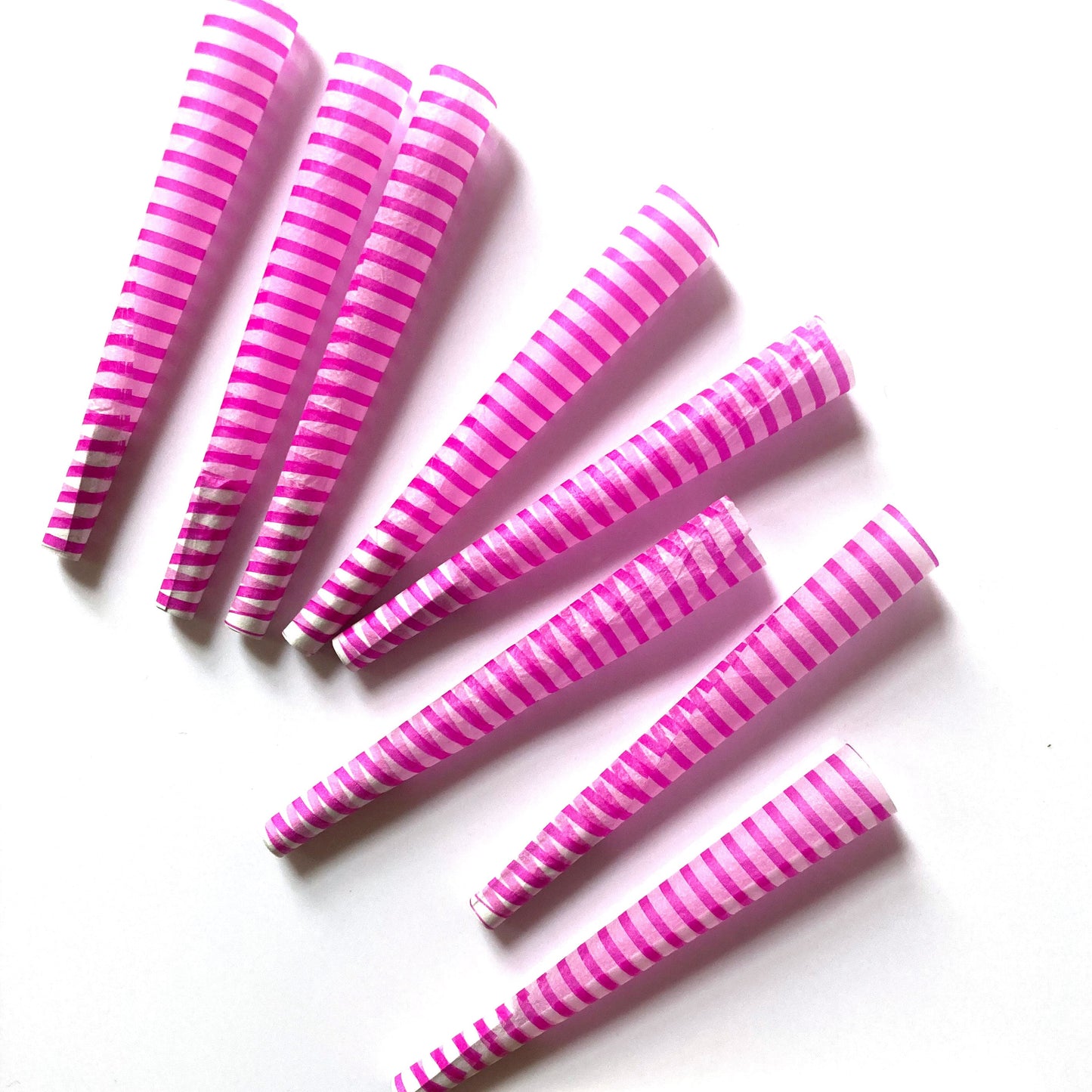 The Poseur Cones, set of 8: magenta striped pre-rolled cones. These designer pre-rolled cones are girly, pretty, vegan, cute, cool, standard size, high quality, even burn, natural dyes, best tasting, slow burn.