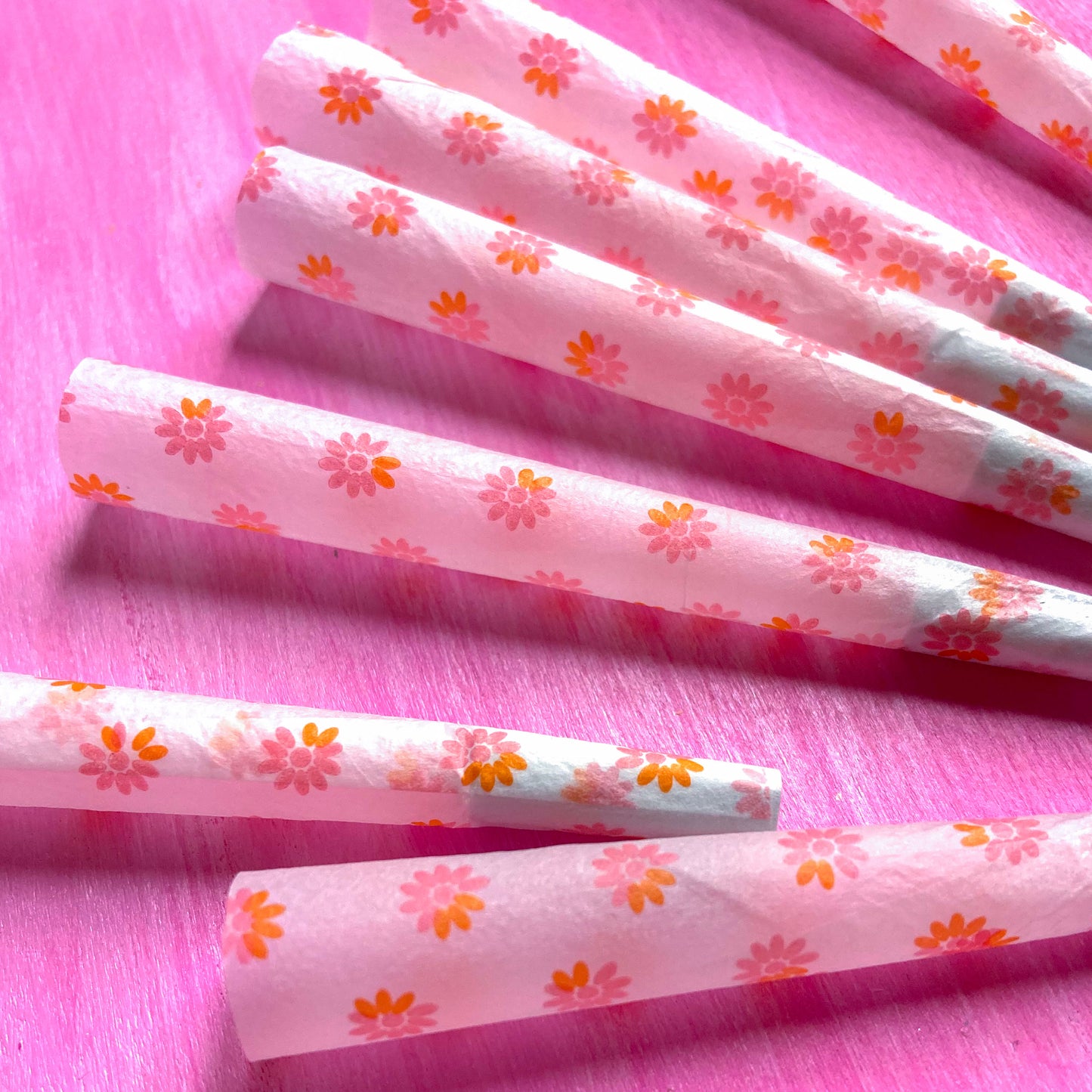 The Fleurt Cones, set of 8: pink and orange floral pre-rolled cones. These designer cones are girly, pretty, vegan, cute, cool, standard size, high quality, even burn, natural dyes, best tasting, slow burn.