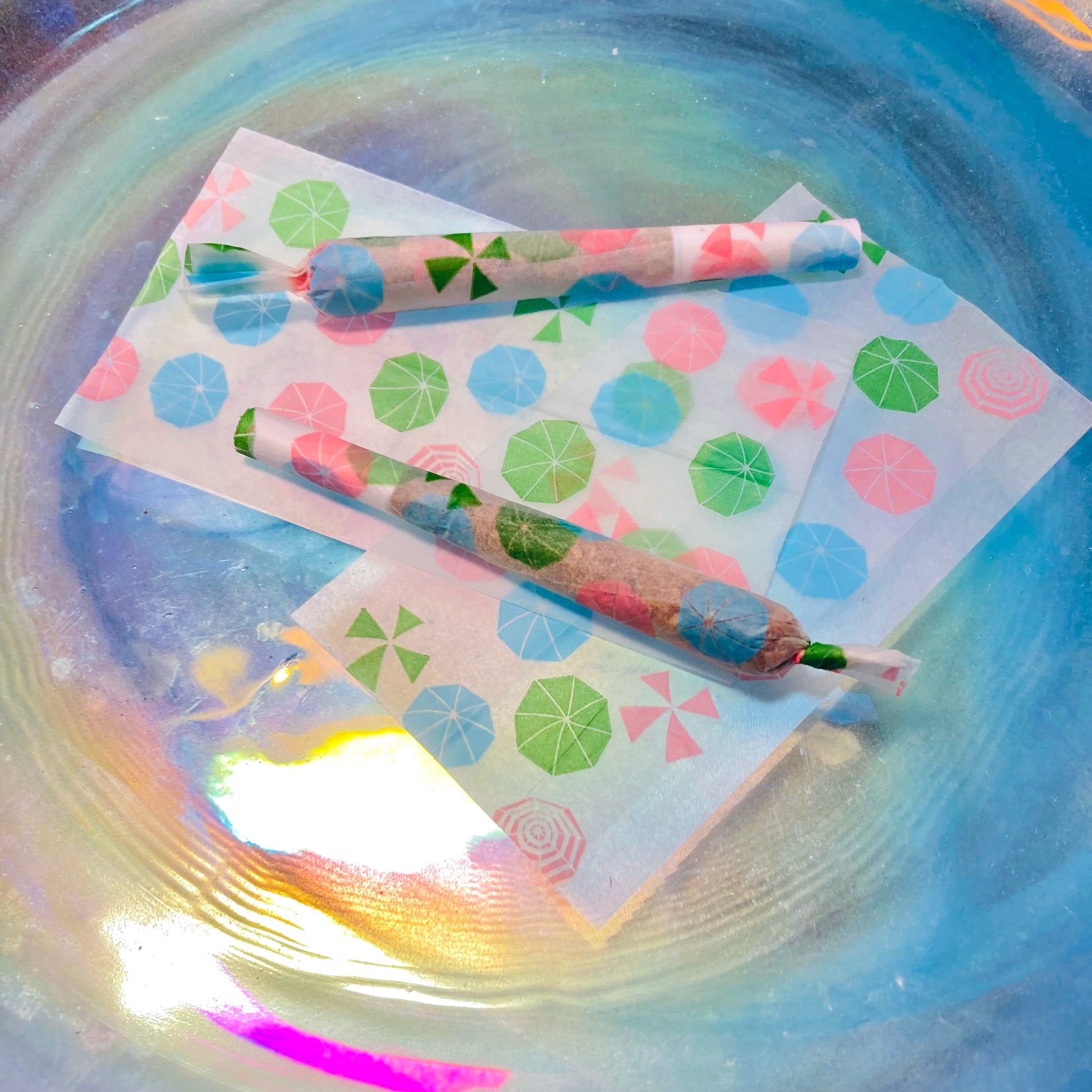 The Boardwalk Papers: beachy parasol, sun umbrella, umbrella printed rolling papers. These designer rolling papers are girly, pretty, vegan, cute, cool, standard size, high quality, even burn, natural dyes, best tasting, slow burn. 