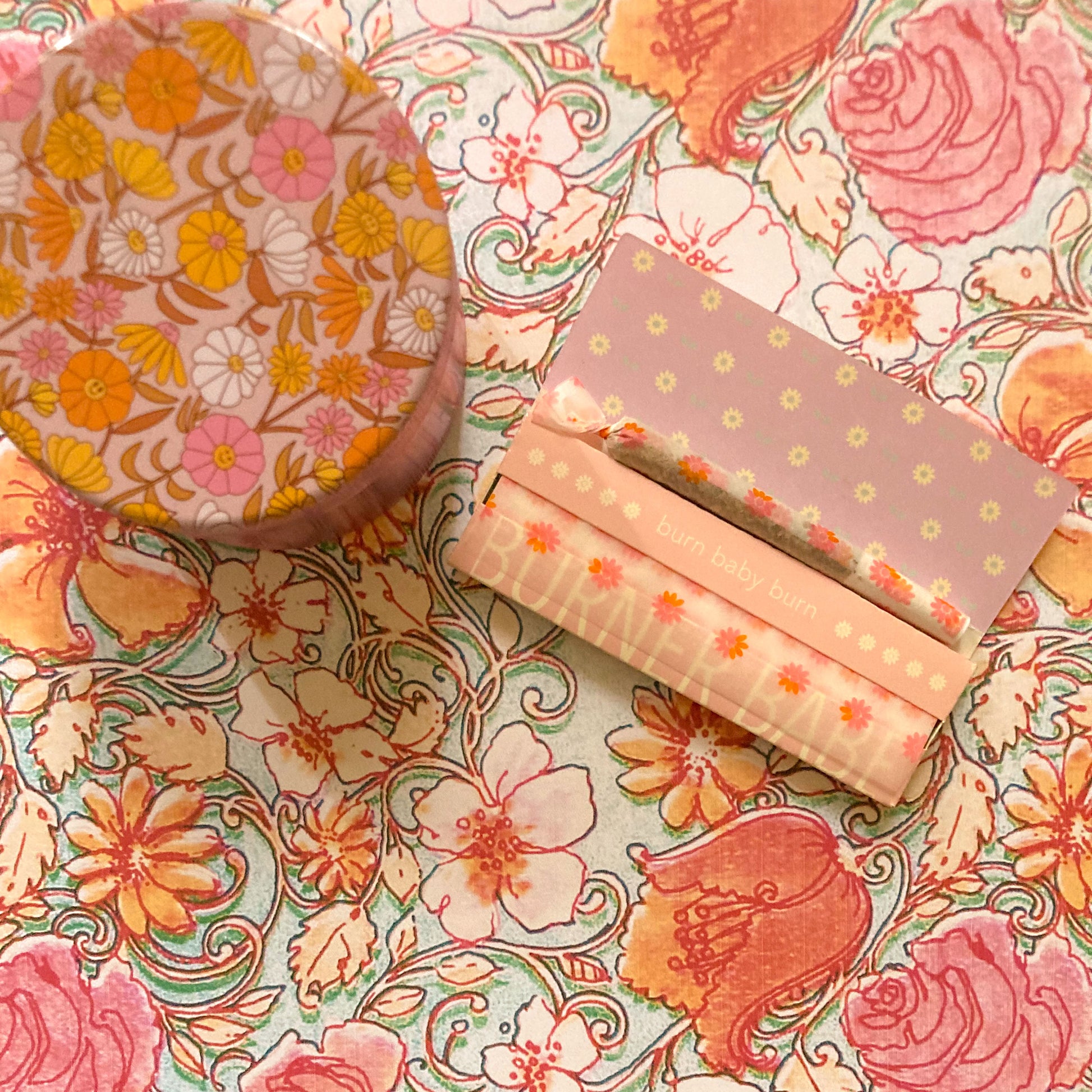 The Fleurt Papers, set of 10: pink and orange floral rolling papers. These designer rolling papers are girly, pretty, vegan, cute, cool, standard size, high quality, even burn, natural dyes, best tasting, slow burn.